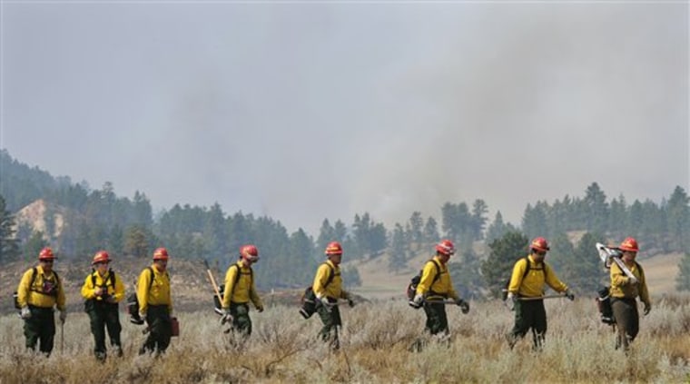 The Fort Belknap Initial Attack crew, led by Scott Bradley, works the Black Springs Complex fire perimeter near Lame Deer, Mont. A lightning-caused wildfire fueled by hot, dry weather and gusty winds grew by thousands of acres overnight and threatened homes on the Northern Cheyenne Indian Reservation, fire officials said Wednesday. 